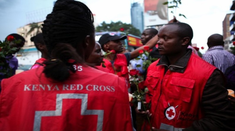 epa04695970 Kenya Red Cross team members hold candles and roses as they attend the second day of candlelight vigil held for the 148 people killed in an attack on Garissa University College in Garissa town, in downtown Nairobi, Kenya, 08 April 2015. Hundreds of Kenyans continue to gather in solidarity to mourn the loss of their countrymen while five terror suspects were arraigned in a Nairobi court on 07 April for supplying attackers with guns used in an attack. Kenyan government on 08 April froze 85 bank accounts linked to suspected supporters of al-Shabab.  EPA/DANIEL IRUNGU